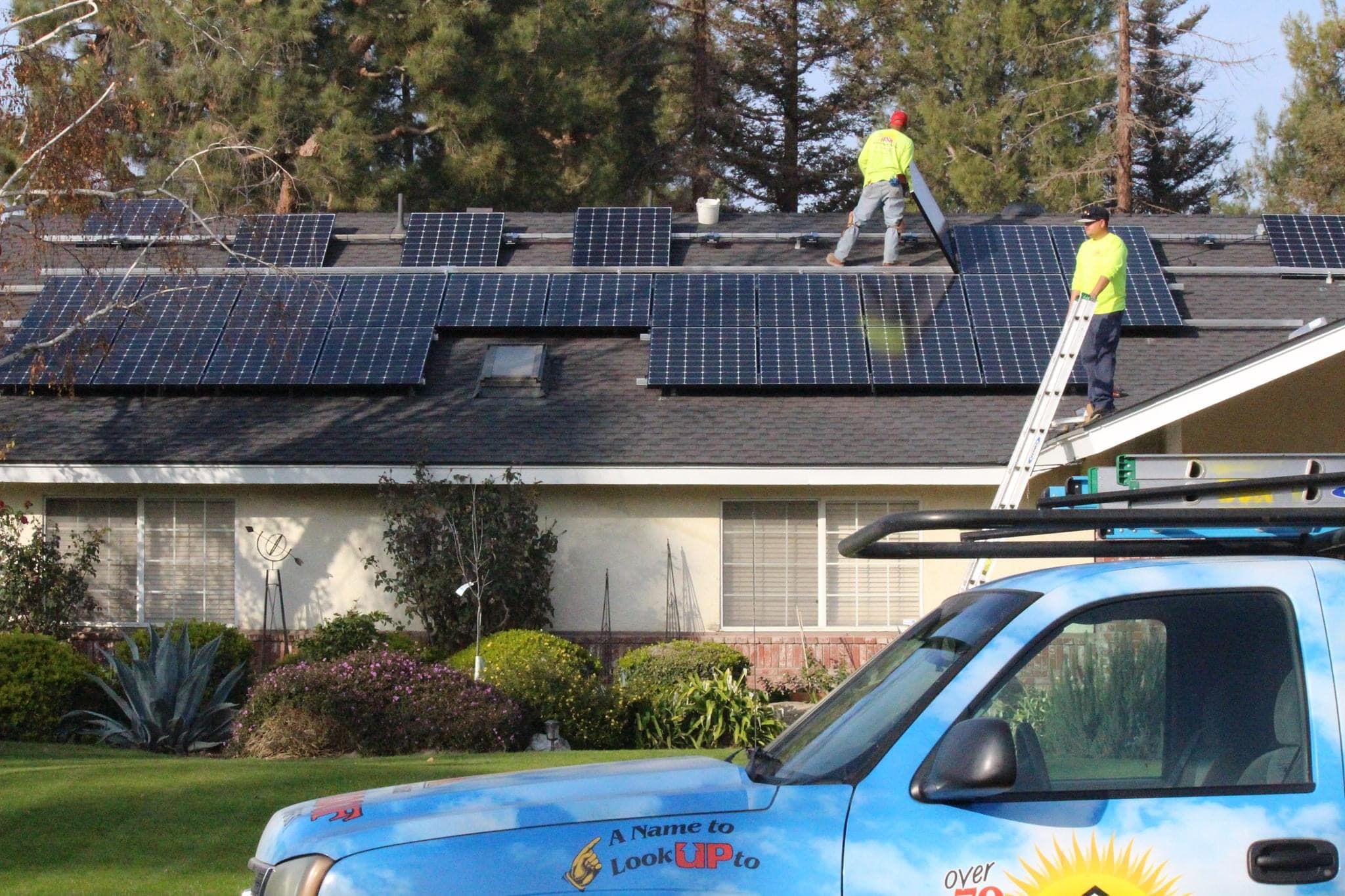 BSW crew servicing solar panels on a tile roof
