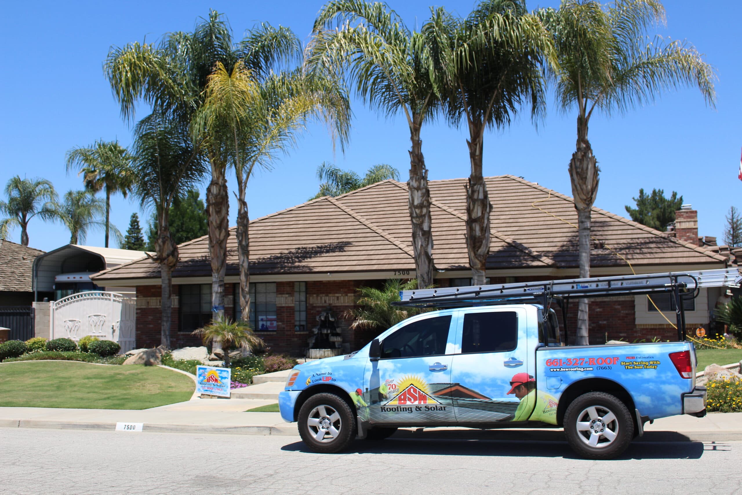A BSW truck parked in front of a freshly finished tile roof in Bakersfield
