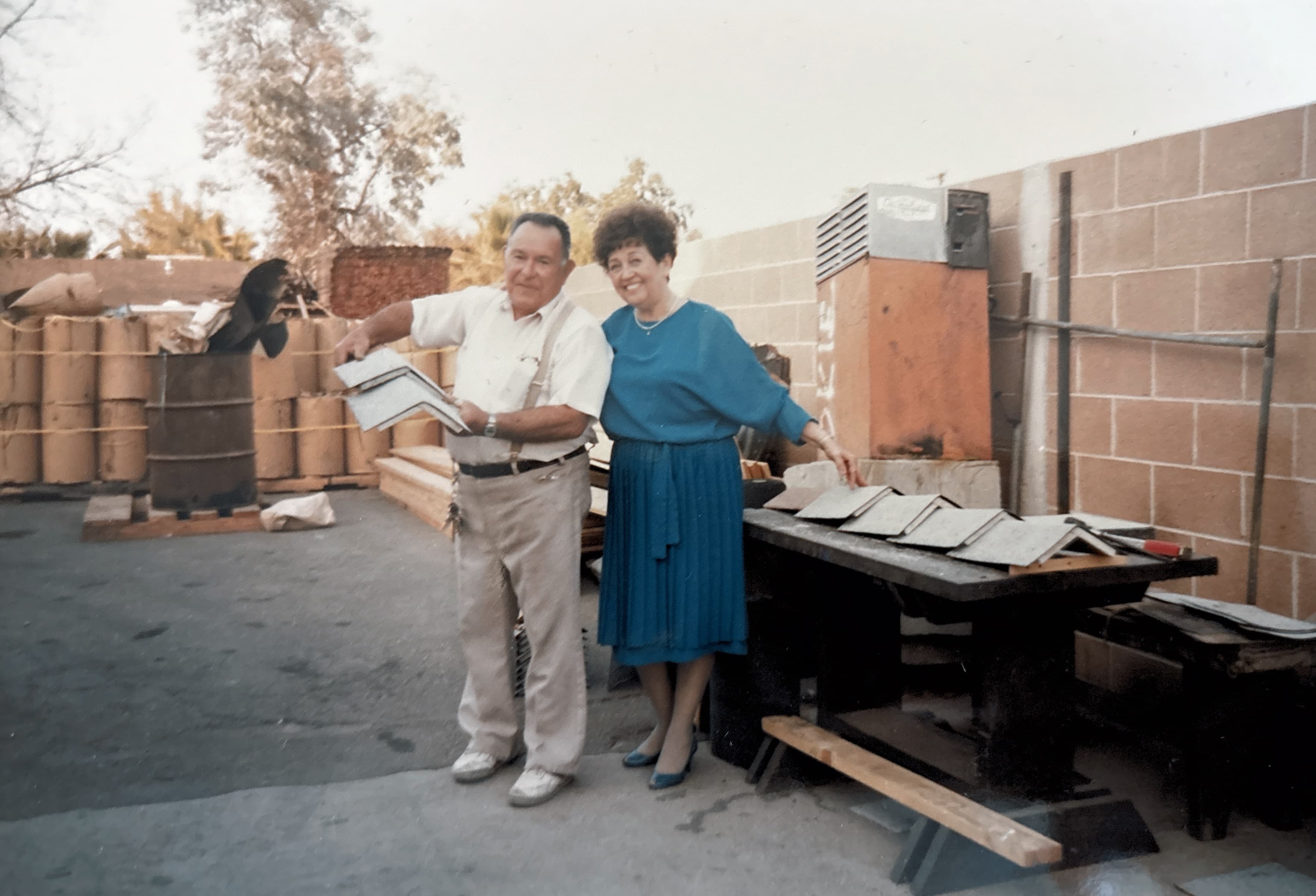 Ernest and Alyce Montoya in the BSW materials yard with shingle samples